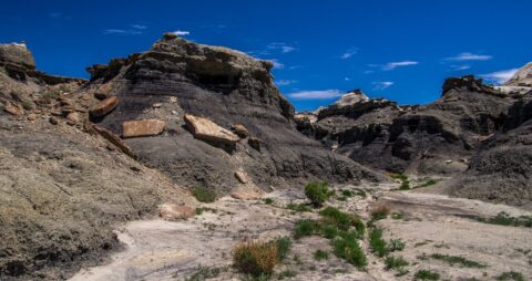 Hiking Through Wash Between Black Hill Area In Bisti Wilderness, NM