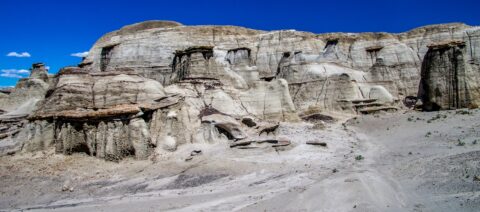 Tight Packed Toadstools And Pale Cliffs In Bisti Wilderness, NM
