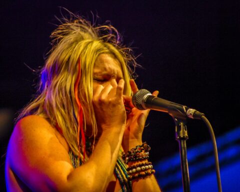 Cathy Richardson, Plays Harmonica On Blues Farm Stage During Heroes Of Woodstock Tour In Winthrop, WA