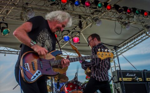 Crossfire Between Leo Lyons And Joe Gooch During Ten Years After Performance On Blues Farm Stage, Heroes Of Woodstock Tour In Winthrrp, WA
