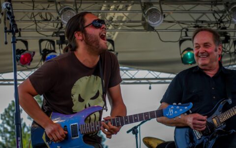 Sam Andrew Enjoys In Ben Nieves Guitar Solo On Blues Farm Stage During Heroes Of Woodstock Tour In Winthrop, WA