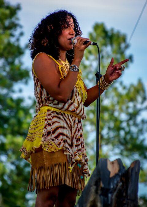 Sophia Ramos Talks To Audience From Blues Farm Stage Performing At Heroes Of Woodstock Tour In Winthrop, WA