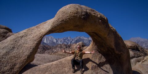 rrasha Sitting Under Mobius Arch In Alabama Hills, CA