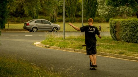 Damjan Rides Scooter Hands Free On The Street In Canberra, ACT, Australia