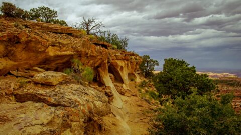 Approaching Anasazi Granary built in an alcove Near Top Of Aztecs Butte In Canyonlands National Park, UT