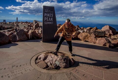 rrasha Climbs On Pikes Peak Summit Stone, CO