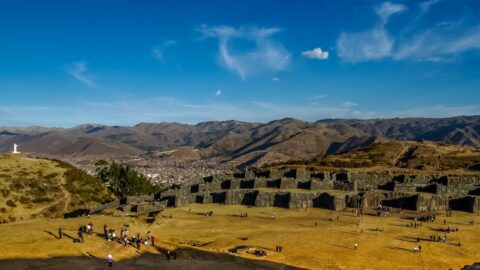 Ruins of Inca’s Capital Saqsaywaman, And White Statue Of Jesus Overlooking Cusco, Peru