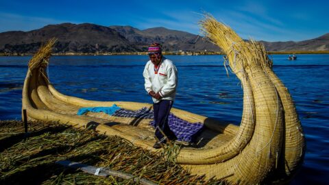 Native Uru Man On The Reed Boat From Uros Islands, Lake Titicaca, Peru