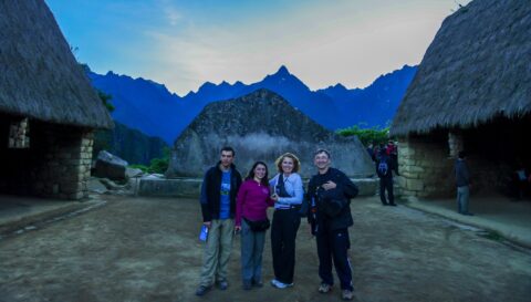 Hiking Team In Front Of The Sacred Rock On Machu Picchu Archeological Site, Peru