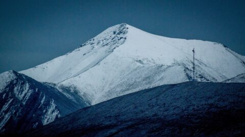 Look From Alaska Highway At Mountain Top Covered With Snow In Stone Mountain Provincial Park, BC