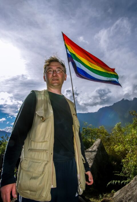 rrasha And Inca Flag On Top Of Putucusi Mountain Accross Machu Picchu In Aguas Calientes, Peru